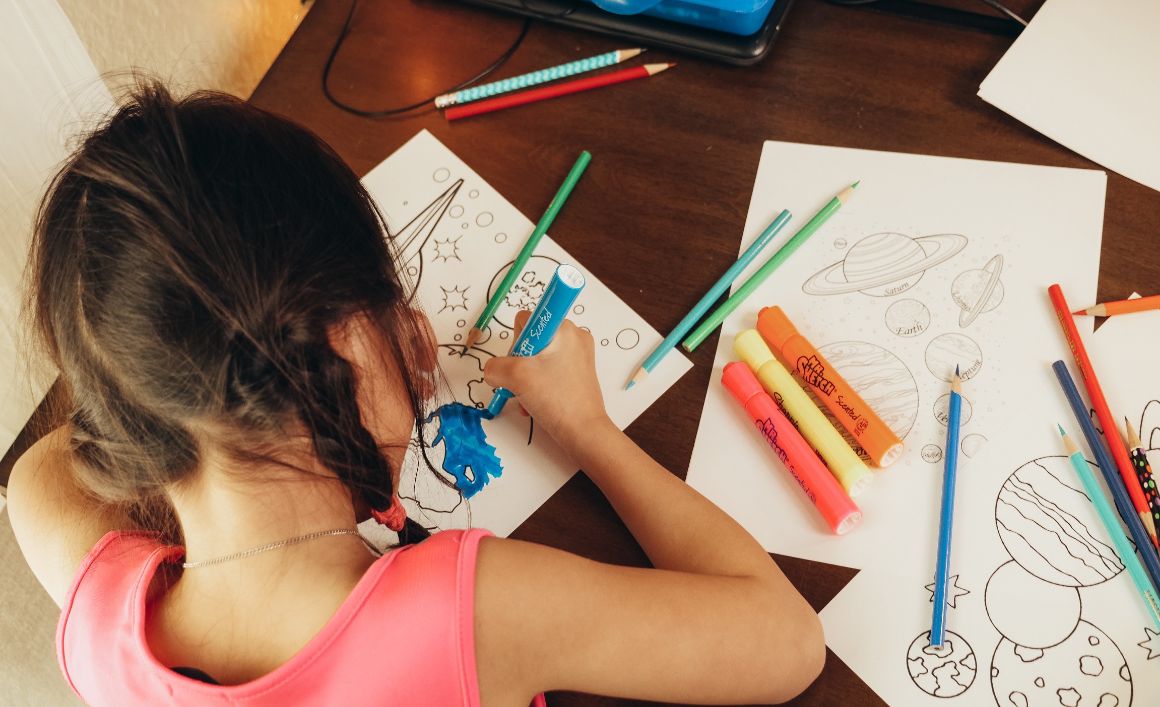 Young girl coloring a coloring book